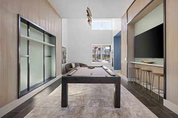 A room with a pool table in the middle at The Quinn Luxury Apartments, Florida, 32526